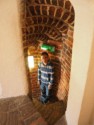Andrew going down a stone spiral staircase